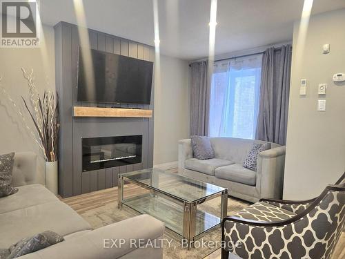 44 - 700 Harmony Road N, Oshawa, ON - Indoor Photo Showing Living Room With Fireplace