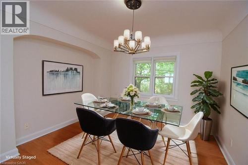 Dining space with hanging lights and light wood-style floors - 136 Glen Road, Hamilton, ON - Indoor Photo Showing Dining Room