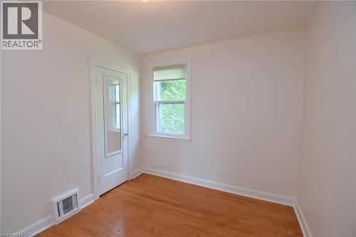 Spare room with light wood-type flooring and baseboards - 136 Glen Road, Hamilton, ON - Indoor Photo Showing Other Room