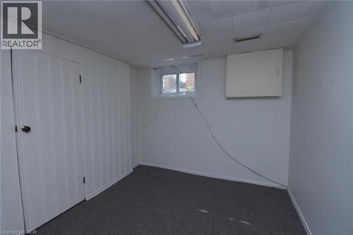 Below grade area with dark colored carpet and baseboards - 136 Glen Road, Hamilton, ON - Indoor Photo Showing Other Room
