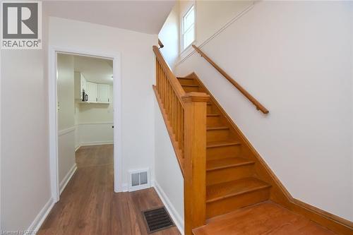 Stairs with wood finished floors and baseboards - 136 Glen Road, Hamilton, ON - Indoor Photo Showing Other Room