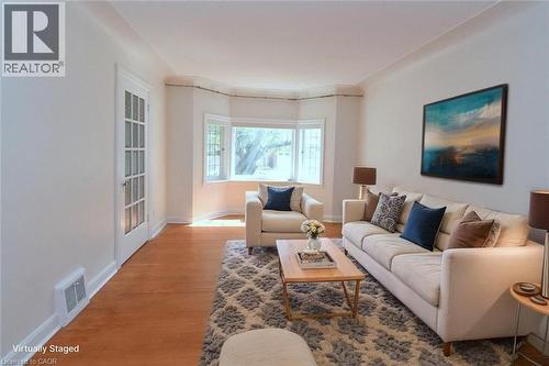 Living room featuring wood finished floors and baseboards - 136 Glen Road, Hamilton, ON - Indoor Photo Showing Living Room