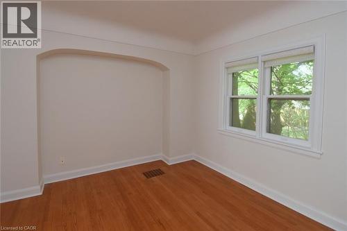 Empty room featuring baseboards and light wood-type flooring - 136 Glen Road, Hamilton, ON - Indoor Photo Showing Other Room