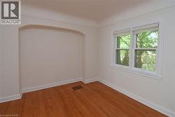 Empty room featuring baseboards and light wood-type flooring - 