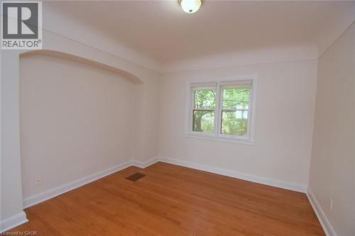 Spare room with baseboards and light wood finished floors - 136 Glen Road, Hamilton, ON - Indoor Photo Showing Other Room