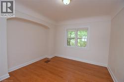 Spare room with baseboards and light wood finished floors - 