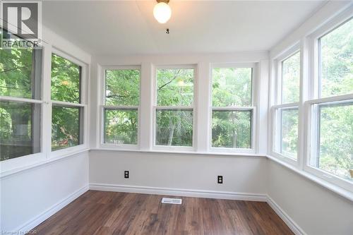 Unfurnished sunroom featuring wood finished floors and healthy amount of natural light - 136 Glen Road, Hamilton, ON - Indoor Photo Showing Other Room
