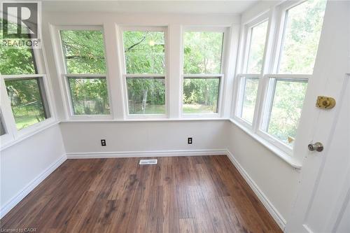 Unfurnished sunroom with hardwood / wood-style flooring and healthy amount of natural light - 136 Glen Road, Hamilton, ON - Indoor Photo Showing Other Room