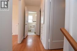 Hallway with light wood-type flooring - 