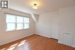 Bonus room with lofted ceiling and light wood-type flooring - 