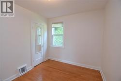 Spare room with light wood-type flooring and baseboards - 