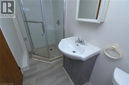 Full bathroom with a stall shower, vanity, and light wood-type flooring - 136 Glen Road, Hamilton, ON - Indoor Photo Showing Bathroom