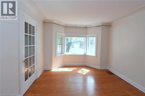 Unfurnished room with light wood-type flooring and baseboards - 136 Glen Road, Hamilton, ON - Indoor Photo Showing Other Room