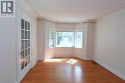 Unfurnished room with light wood-type flooring and baseboards - 