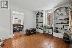 Sitting room featuring a chandelier and dark wood-type flooring - 