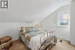 Carpeted bedroom with vaulted ceiling and a textured ceiling - 