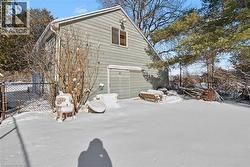 View of snow covered exterior featuring a garage - 