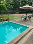 Swimming pool featuring a patio area and outdoor dining area - 