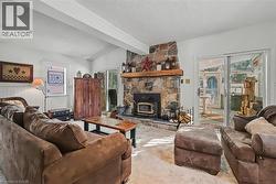 Carpeted living room with a textured ceiling and a wainscoted wall - 