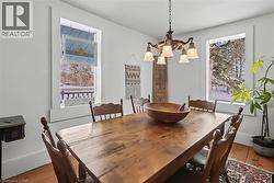 Dining space featuring wood-type flooring and a chandelier - 