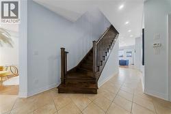 Stairway featuring tile patterned floors and recessed lighting - 
