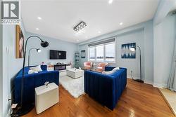 Living area with hardwood / wood-style flooring and recessed lighting - 