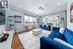 Living room with wood finished floors and recessed lighting - 