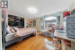Bedroom with light wood-style floors and a closet - 
