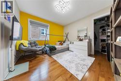 Bedroom with hardwood / wood-style floors and a spacious closet - 
