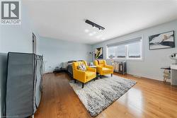 Sitting room featuring light wood-style flooring - 