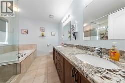 Bathroom with a bath, double vanity, and a shower - 