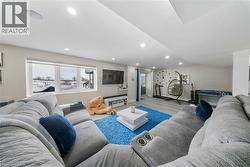 Living room with recessed lighting and wood finished floors - 