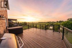 Deck at dusk featuring grilling area - 
