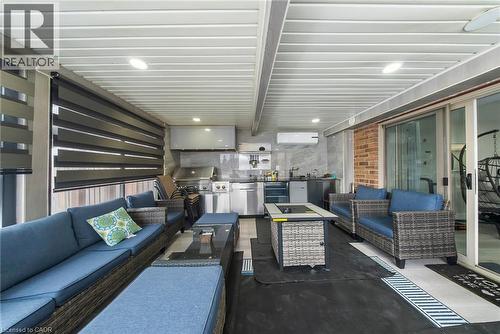 View of patio / terrace featuring a mini split for heating / cooling and an outdoor kitchen with living area - 59 Greti Drive, Hamilton, ON - Indoor
