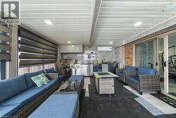 View of patio / terrace featuring a mini split for heating / cooling and an outdoor kitchen with living area - 
