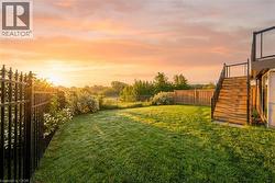 Fenced backyard featuring stairs - 