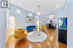 Living area with wood-type flooring and suspended lighting - 