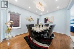 Dining room featuring light wood finished floors and recessed lighting - 
