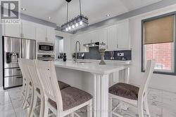 Kitchen with pot lights and chandelier - 