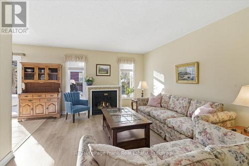 Two Bright south Facing Windows Flank Fireplace - 25 Apple Tree Crescent, Uxbridge, ON - Indoor Photo Showing Living Room With Fireplace