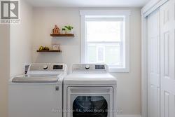 Main floor laundry with floating shelves - 