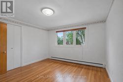 Bedroom 2 facing backyard with original hardwood - 