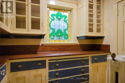 Butler's pantry with original stained glass. - 