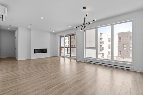 Salle à manger - 305-13225 Boul. Du Curé-Labelle, Mirabel, QC - Indoor Photo Showing Living Room With Fireplace