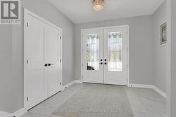 Beveled glass front doors open to bright foyer - 