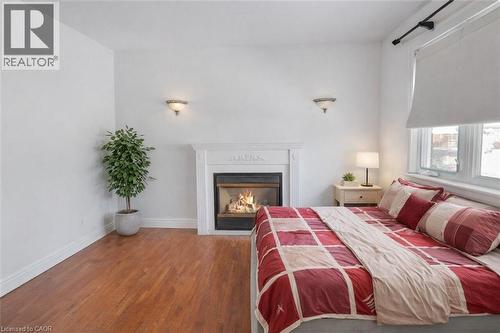 VR STAGED - 28 West 3Rd Street, Hamilton, ON - Indoor Photo Showing Bedroom With Fireplace