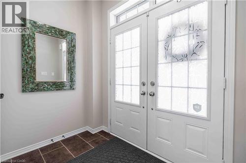 Welcoming double-door entry to front foyer - 115 Larry Crescent, Caledonia, ON - Indoor Photo Showing Other Room
