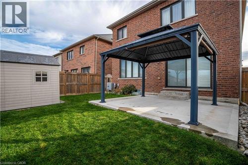 Back of property with a gazebo, a fenced backyard, a patio, and brick siding - 115 Larry Crescent, Caledonia, ON - Outdoor With Exterior