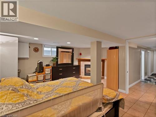 Bedroom featuring a tile fireplace, light tile patterned floors, and recessed lighting - 210 East 24Th Street, Hamilton, ON - Indoor