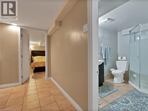 Ensuite bathroom with light tile patterned flooring, vanity, and a stall shower - 210 East 24Th Street, Hamilton, ON - Indoor Photo Showing Bathroom